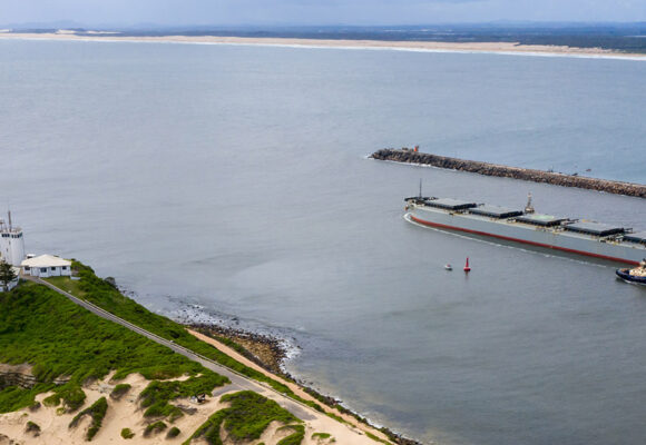 newcastle nsw port, ship accompanied by tug boats, stockton beach