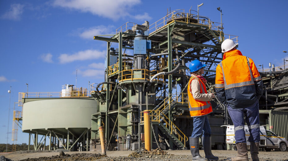 Mining industry workers examining machinery